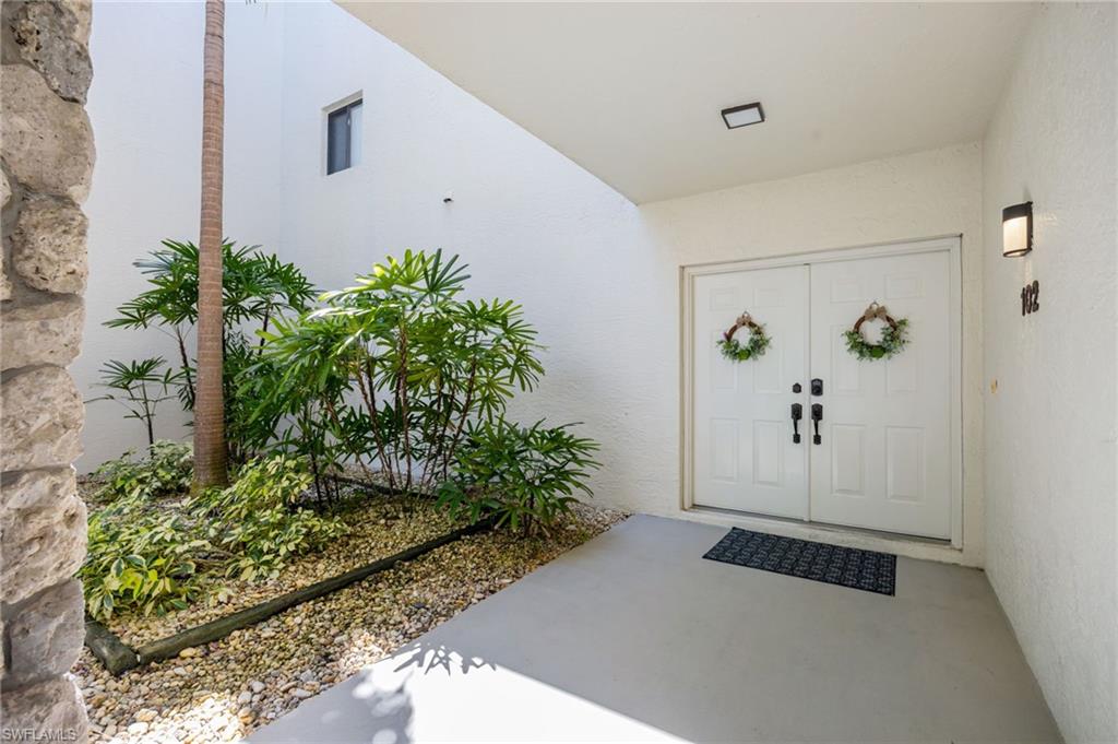 Doorway to property with stucco siding