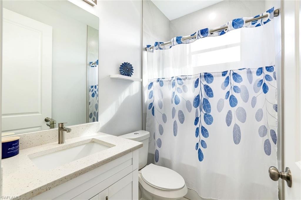 Bathroom with vanity and shower / bath combo with shower curtain