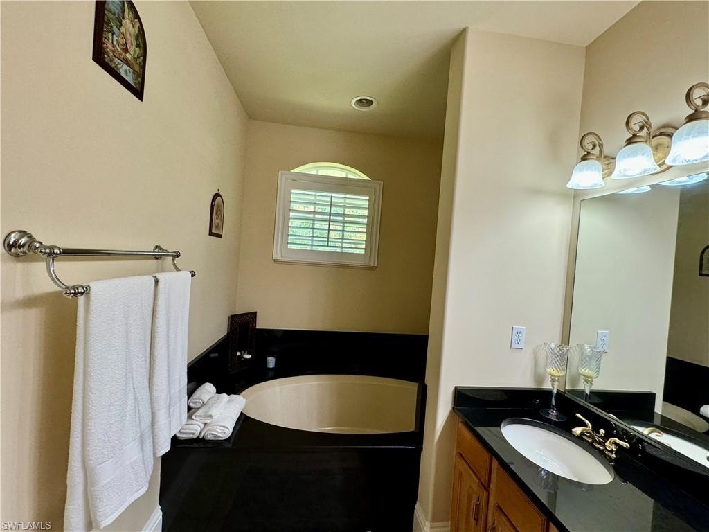 Bathroom with a bath and vanity