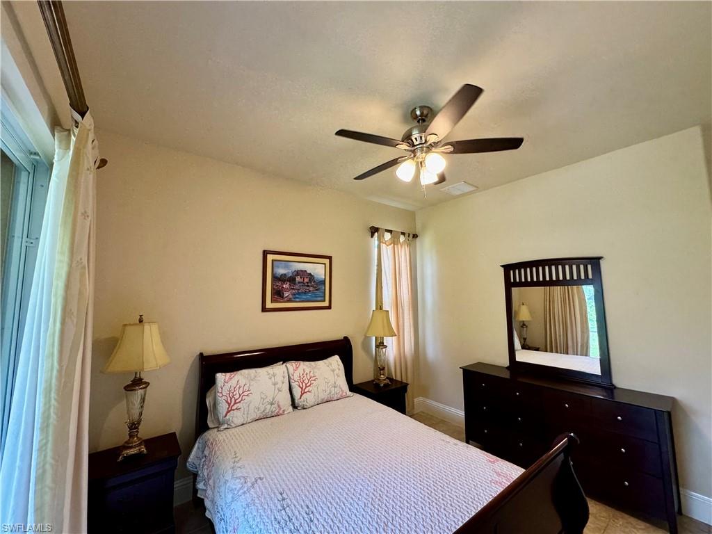 Bedroom with a ceiling fan and baseboards