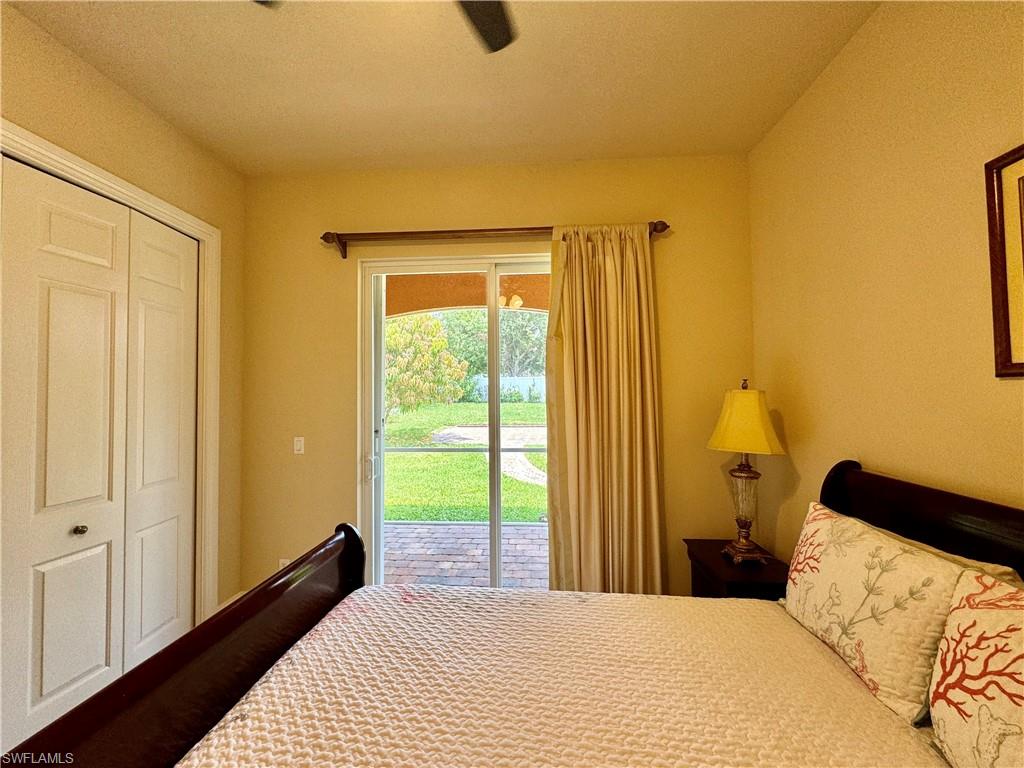 Bedroom featuring access to exterior, a closet, and a ceiling fan