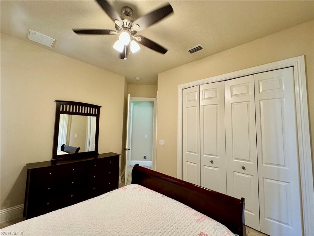 Bedroom with a ceiling fan and a closet