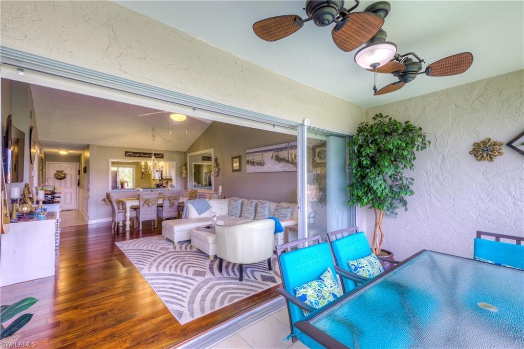 View of patio / terrace featuring a ceiling fan, a wooden deck, and an outdoor bar and dining area