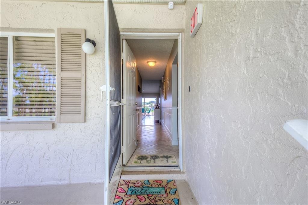 Entrance to property with stucco siding