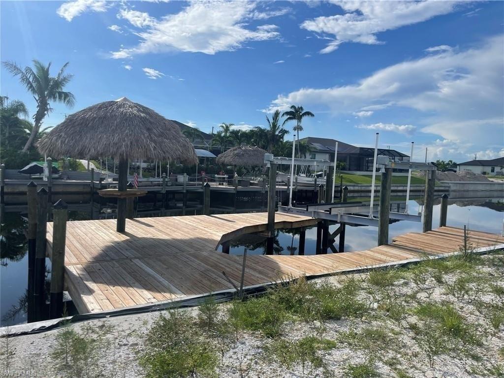Dock area featuring a water view and boat lift