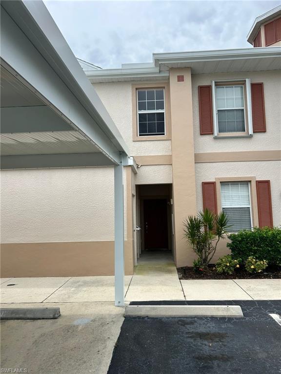 View of exterior entry with stucco siding