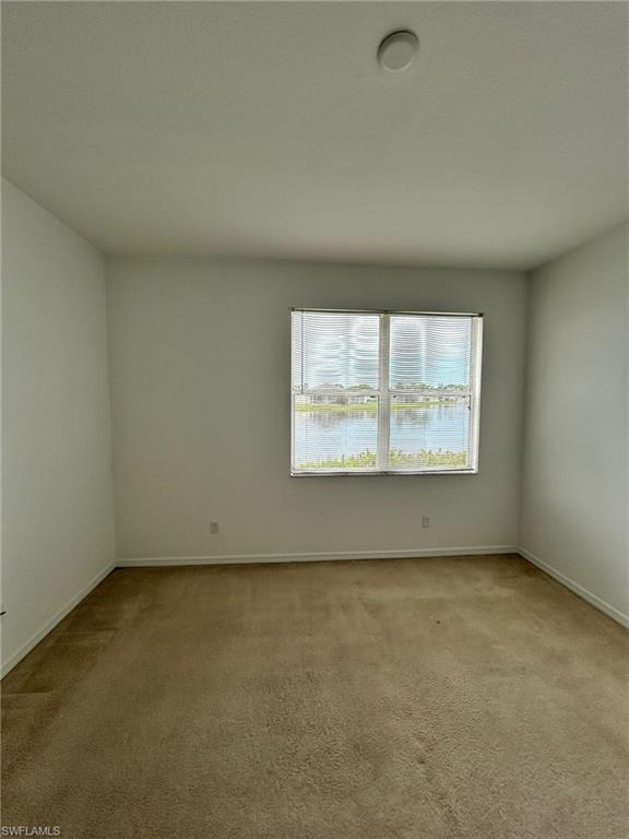 Spare room with light colored carpet
