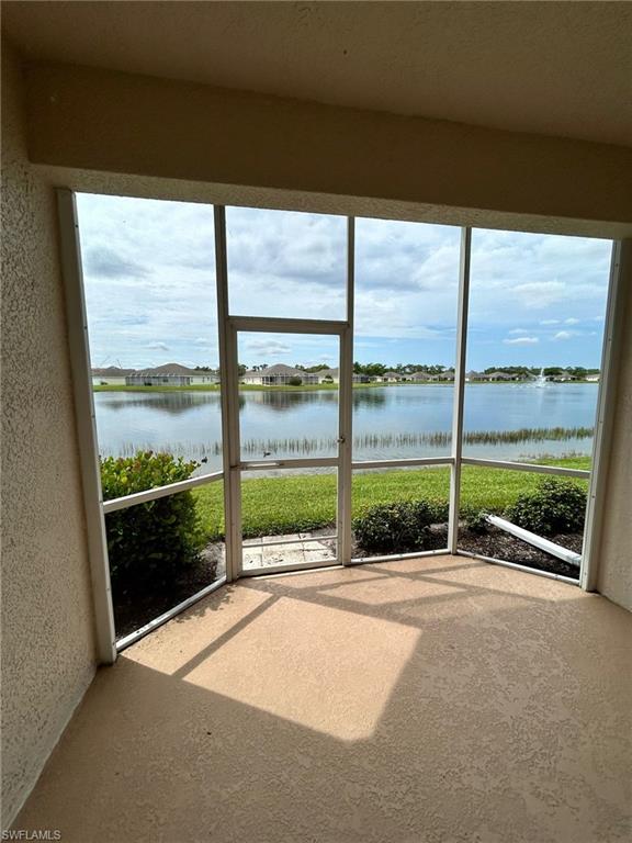 Unfurnished sunroom with a water view and plenty of natural light