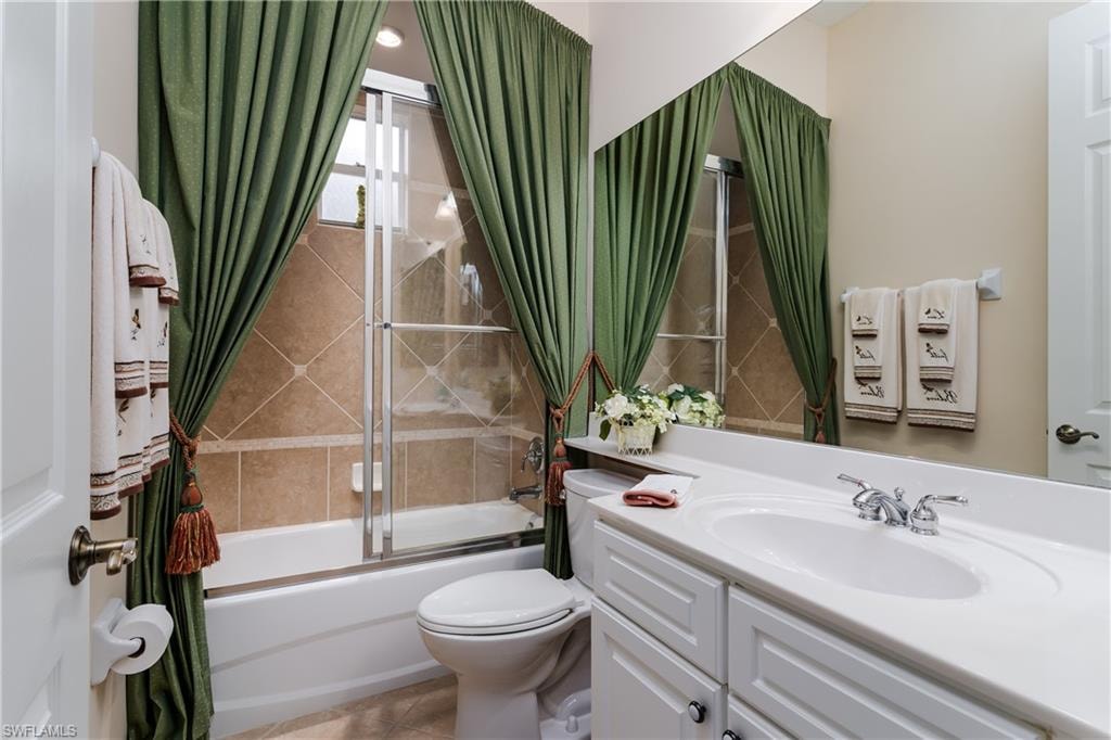 Home office with light colored carpet, french doors, and ceiling fan