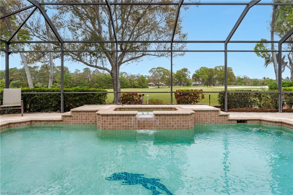Swimming pool featuring a lanai, a sunroom, an in-ground hot tub, and a patio area
