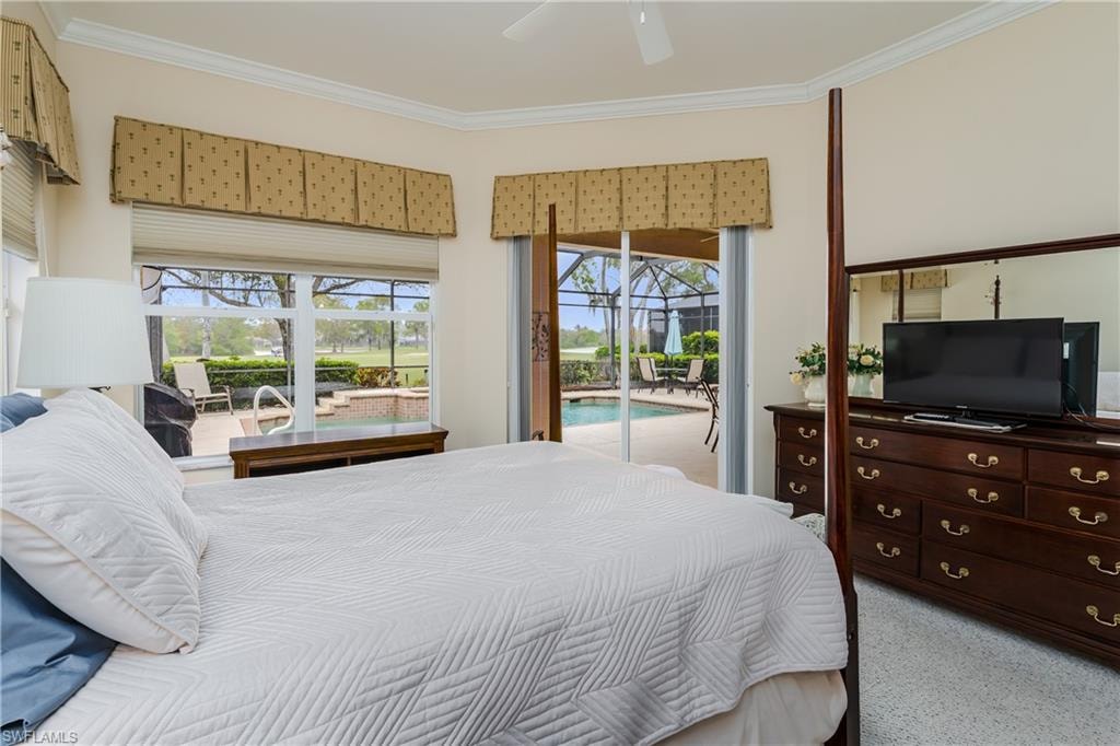 Bedroom with a sunroom, access to exterior, a ceiling fan, ornamental molding, and light carpet