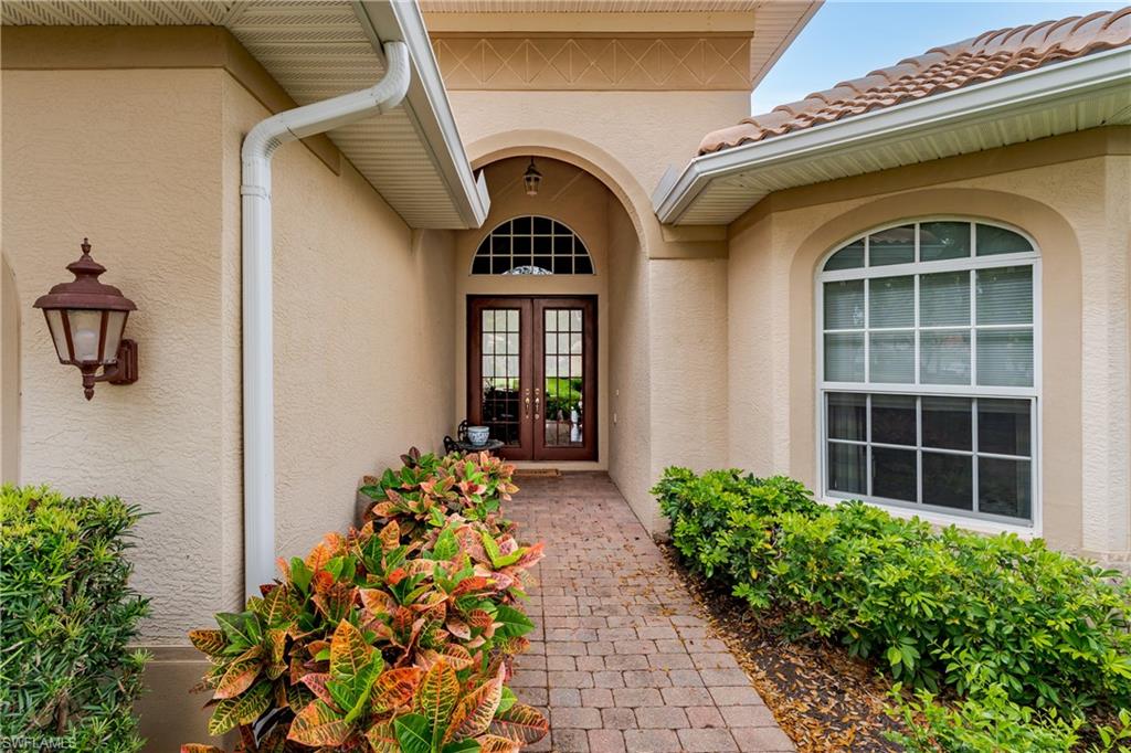Property entrance with stucco siding and french doors