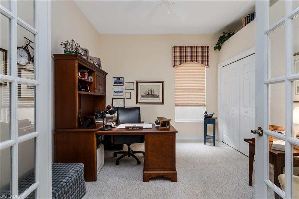 Home office with light colored carpet, french doors, and ceiling fan