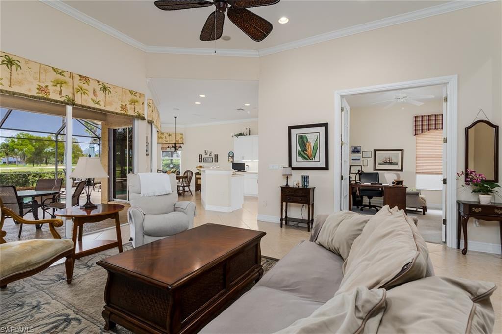 Living area with ceiling fan, ornamental molding, recessed lighting, light tile patterned floors, and a sunroom