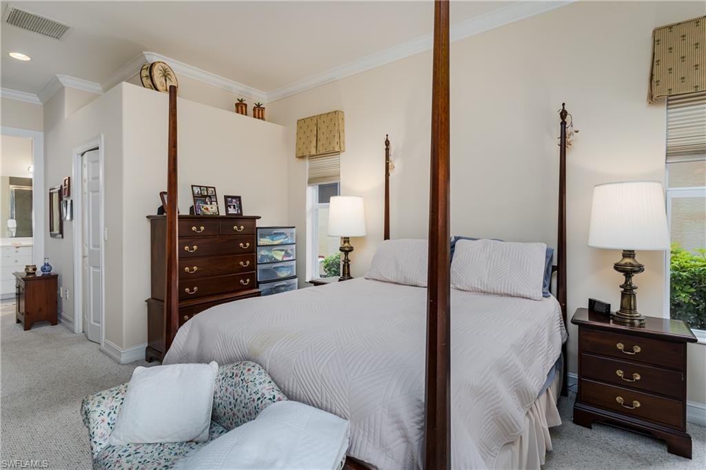 Bedroom with light carpet, crown molding, ensuite bathroom, and recessed lighting