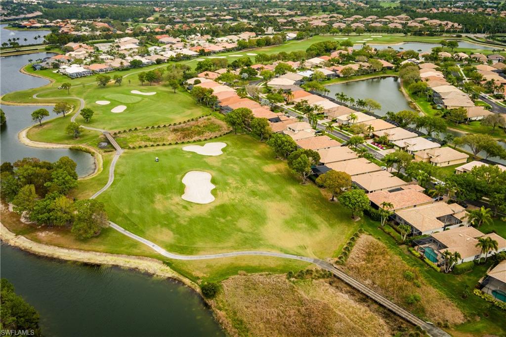 View of property location with a large body of water, nearby suburban area, and a golf club