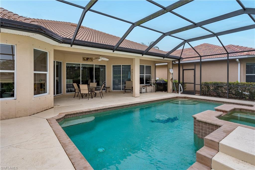 Integrated pool / hot tub with outdoor dining area, a patio area, and a sunroom