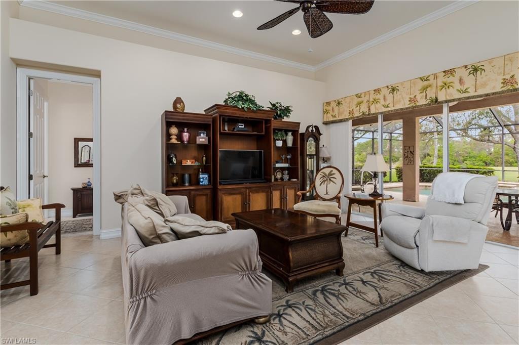 Living area featuring a ceiling fan, crown molding, light tile patterned flooring, and recessed lighting