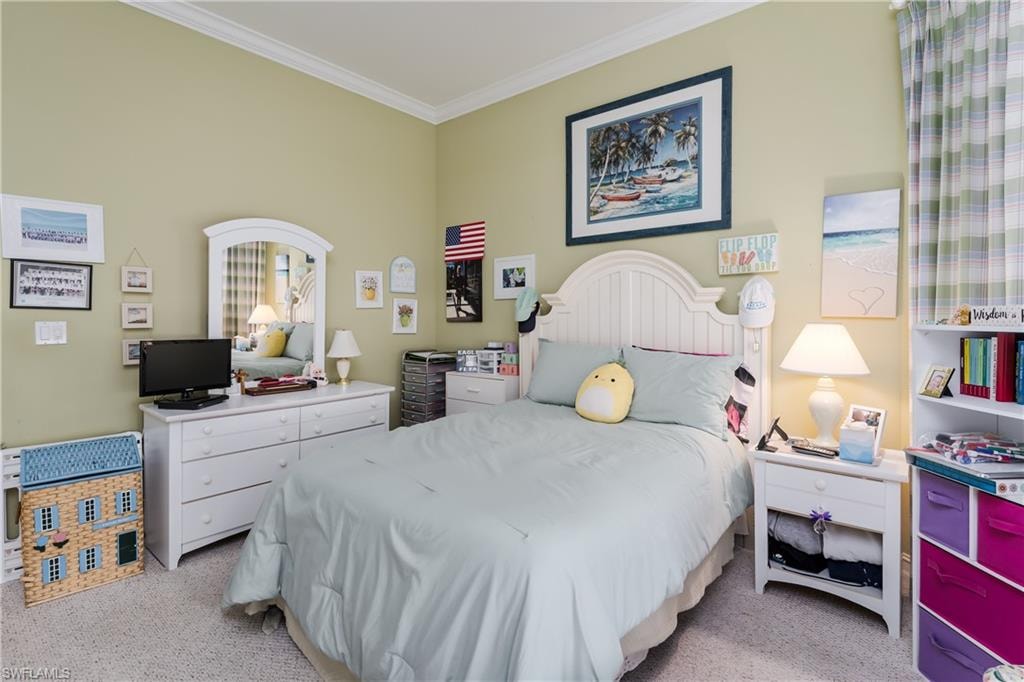 Bedroom featuring ornamental molding and light carpet