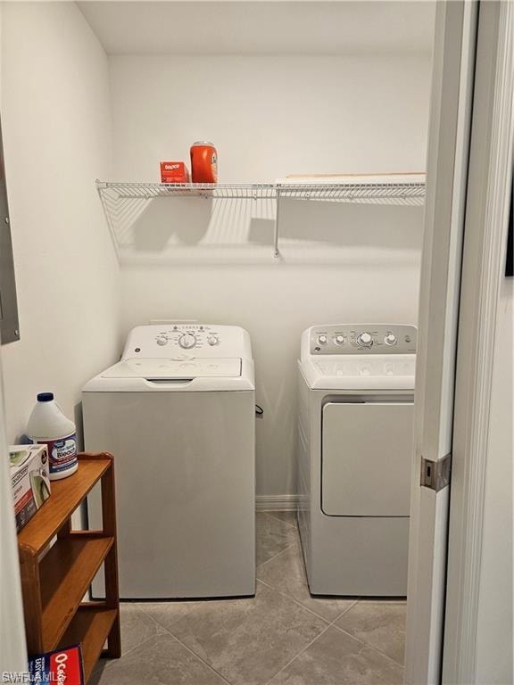 Washroom featuring washing machine and dryer and laundry area