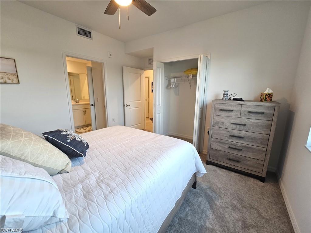 Bedroom with baseboards, carpet floors, visible vents, a ceiling fan, and a closet