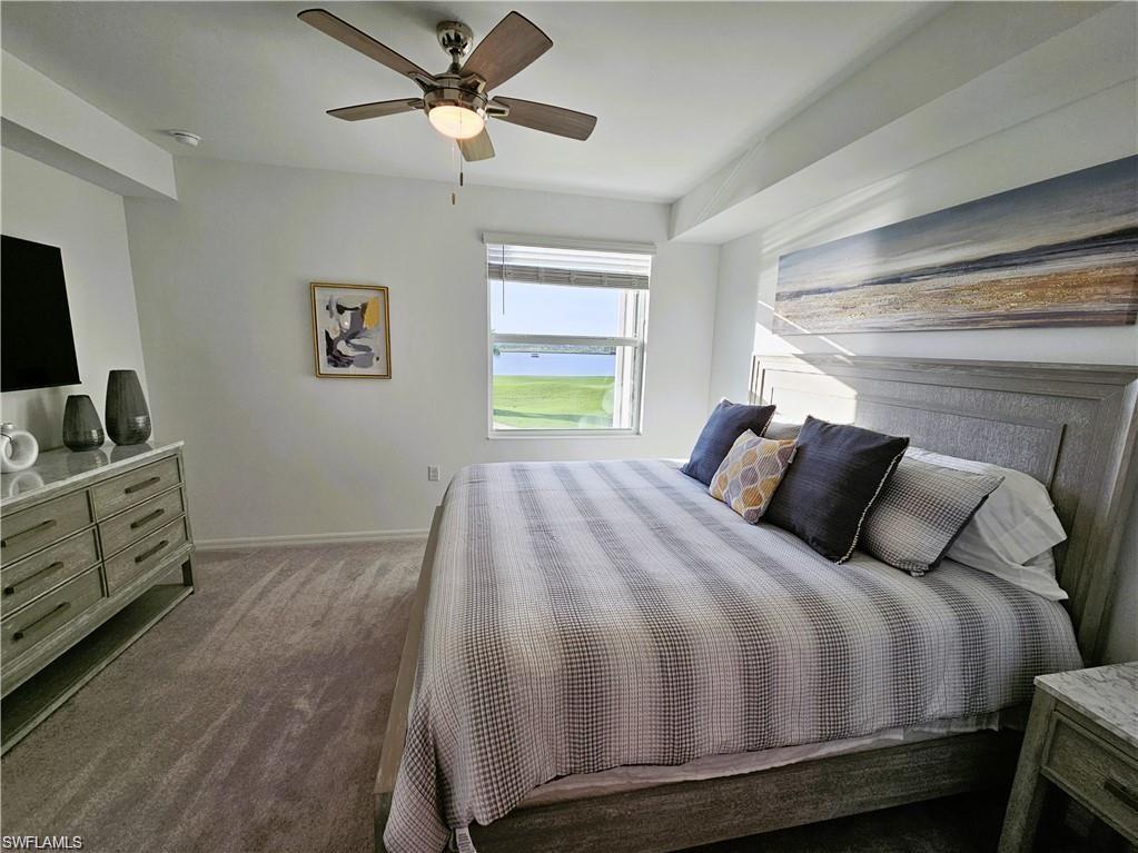 Bedroom with baseboards, carpet floors, and a ceiling fan