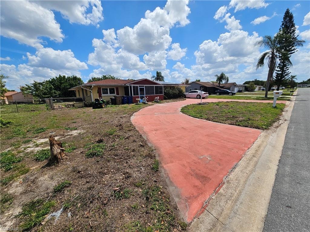 View of front facade with curved driveway