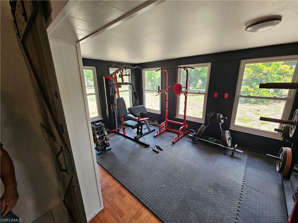 Workout area featuring plenty of natural light and a textured ceiling