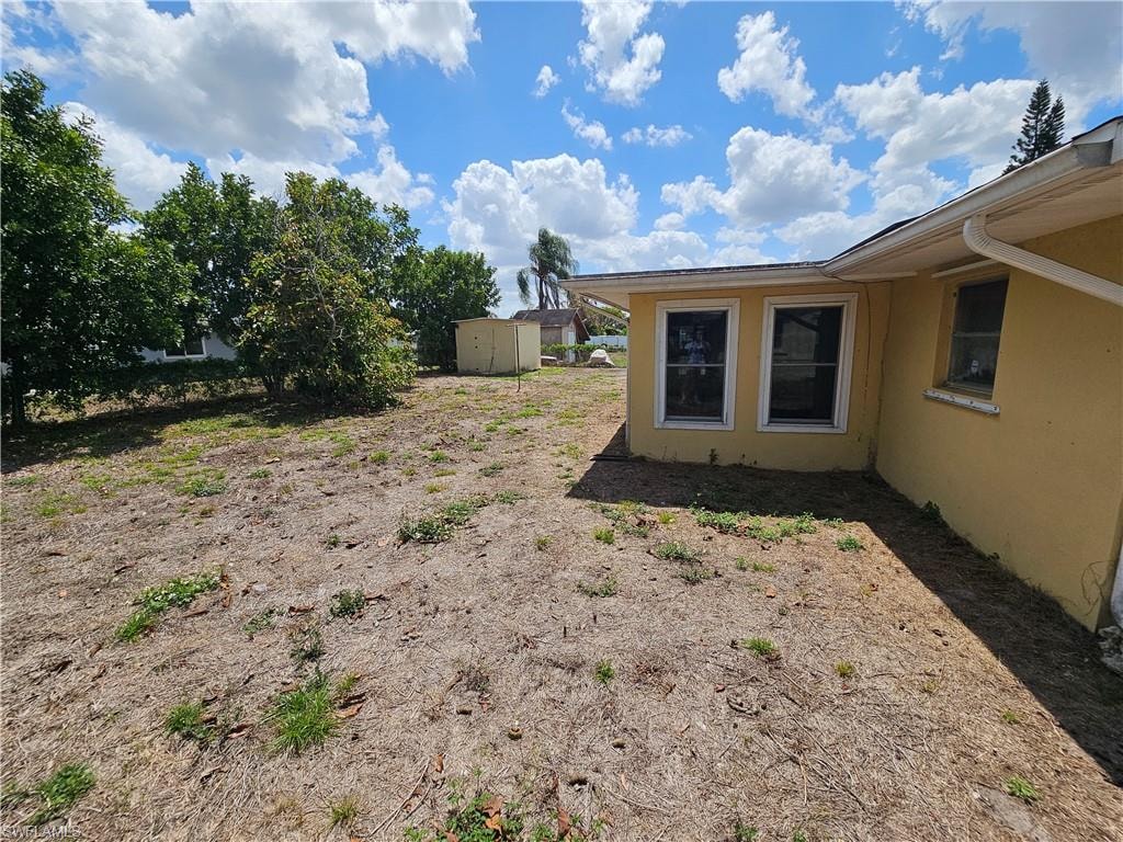 View of yard with a storage unit