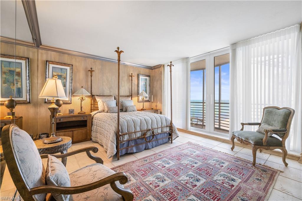 Bedroom with access to exterior, light tile patterned flooring, and a water view