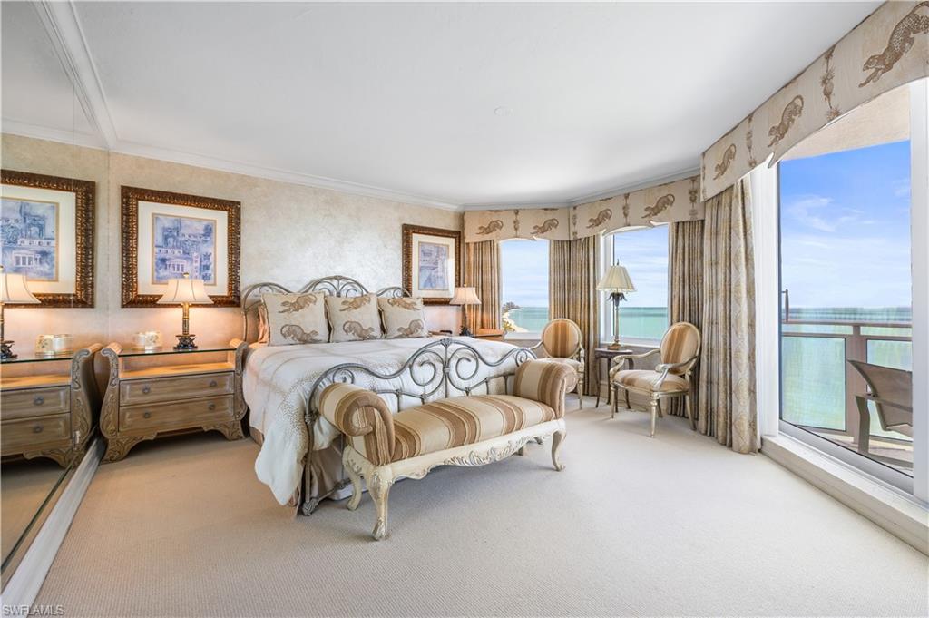 Master Bedroom featuring carpet, a water view, crown molding, and wallpapered walls