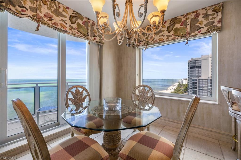 Tiled dining area with hanging lights and a water view
