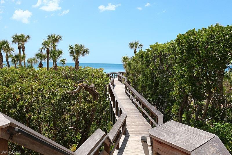 Path to Beach View of property's community featuring view of water and beach