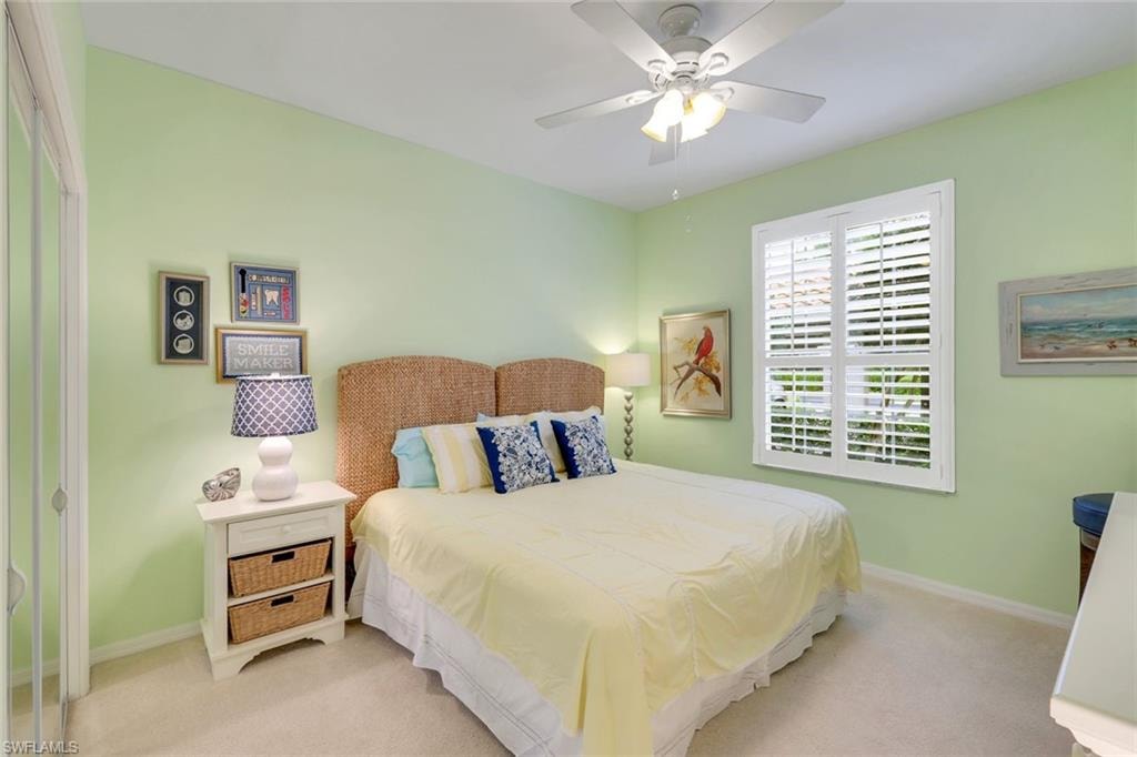 Guest bedroom with ceiling fan, plantation shutters, and pocket door added to the hallway to create a private guest wing!