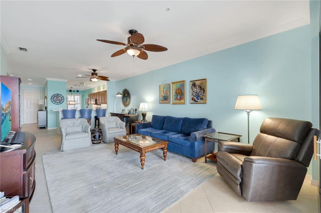 Lovely Open Living Area Overlooking Gorgeous Water Views, Updated Fan/Light Fixtures, Crown Molding and Neutral Tile on the Diagonal!