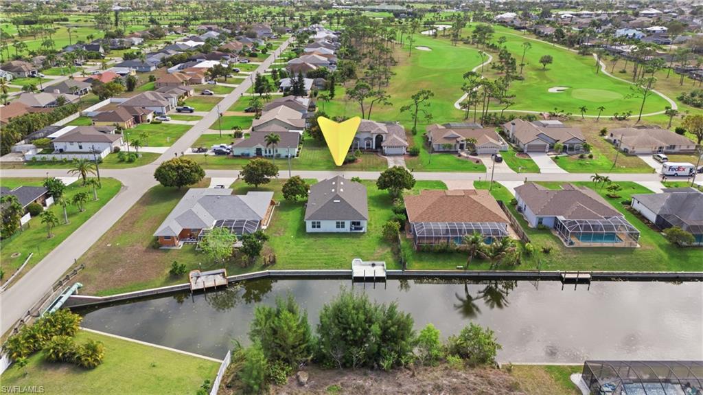 Aerial view of residential area with a local golf course and a nearby body of water