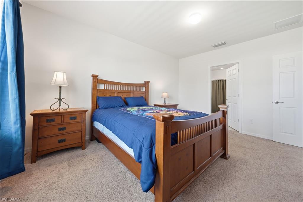 Bedroom featuring carpet floors and ensuite bath