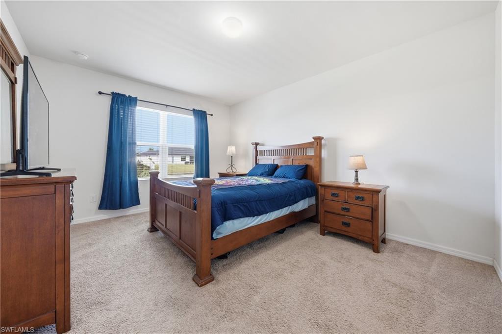 Bedroom featuring light colored carpet