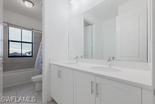 Full bathroom featuring double vanity, shower / bath combination with curtain, and light tile patterned floors