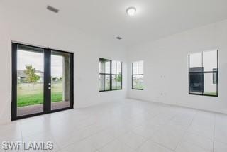 Empty room with plenty of natural light and light tile patterned floors