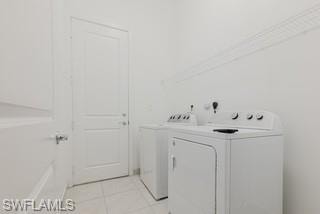 Laundry area featuring independent washer and dryer and light tile patterned floors