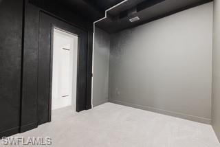 Spare room with light carpet and baseboards