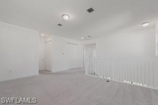 Spare room with light colored carpet