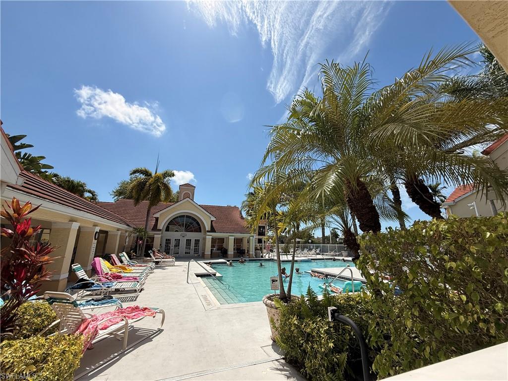 Community pool with french doors and a patio area