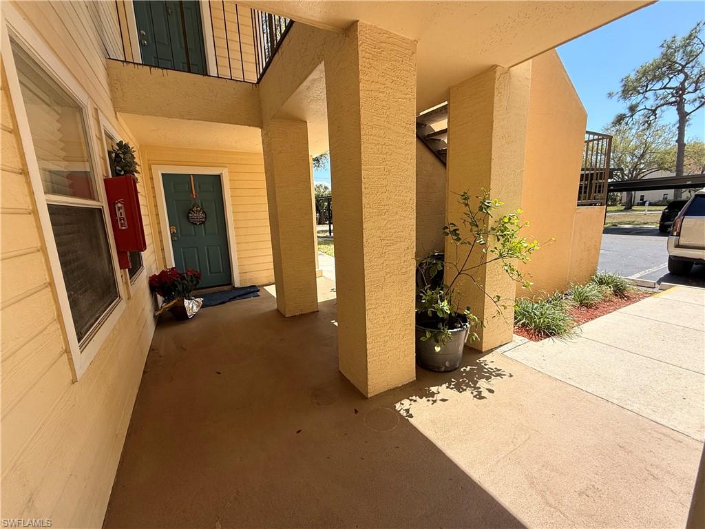 View of exterior entry with stucco siding