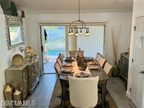 Dining room featuring crown molding and suspended lighting
