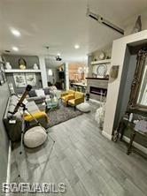 Living room with wood finished floors and a fireplace