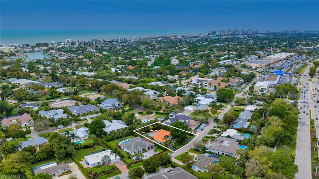 Aerial view of property's location with property parcel outlined and nearby suburban area