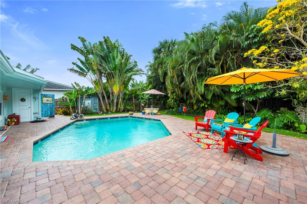 View of pool with patio surround and a fenced backyard