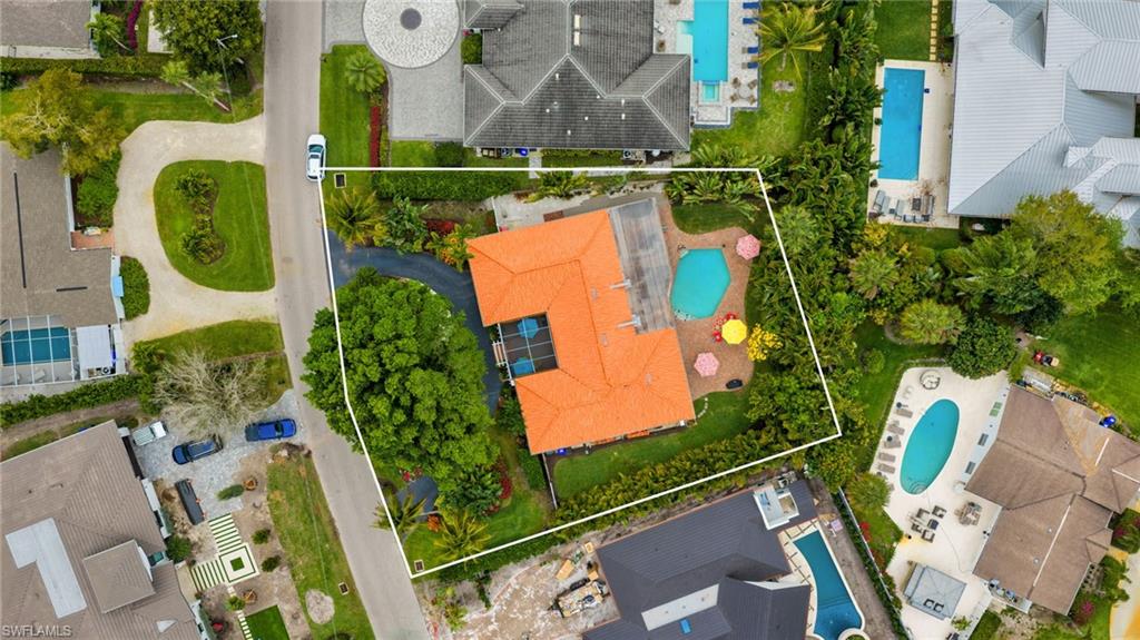 Aerial view of residential area with a pool and property parcel outlined